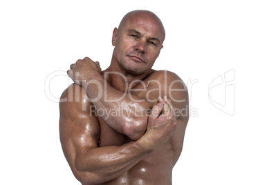 Portrait of bodybuilder stretching with hands