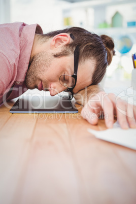 Businessman napping with head on desk