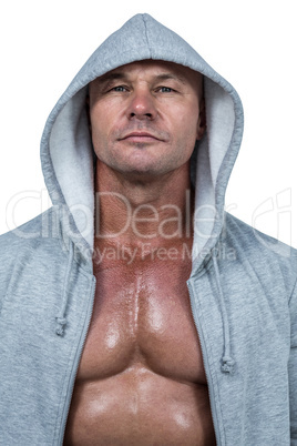 Portrait of confident bodybuilder in hood