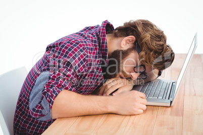 Hipster resting with head on laptop