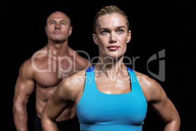 Muscular trainers looking away