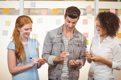 Business people writing on adhesive notes