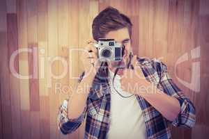 Hipster showing thumbs up while photographing