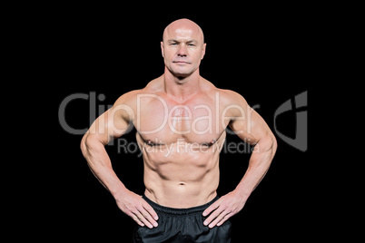 Portrait of confident bald man with hands on hip