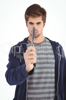 Portrait of man holding straight edge razor