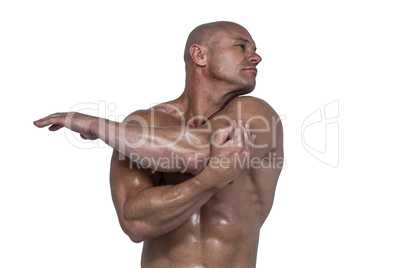 Muscular man stretching hands