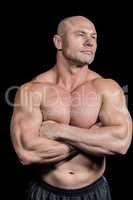 Muscular fit man with arms crossed