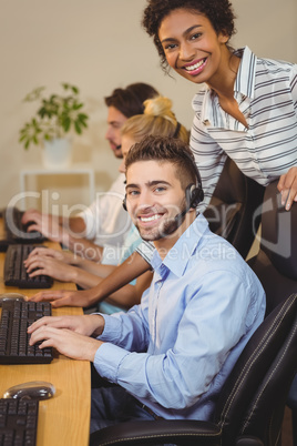 Smiling businesswoman with male employee