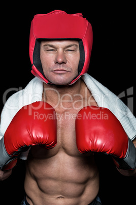 Confident boxer against black background