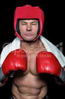 Confident boxer against black background