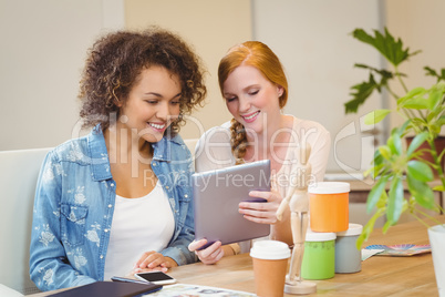 Businesswoman showing something to female colleague