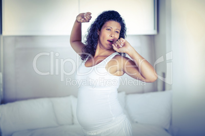Lazy pregnant woman yawning