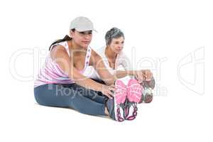 Women touching toes while exercising