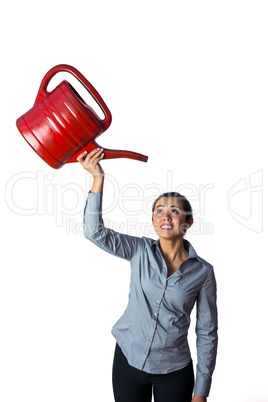 Happy woman holding a watering can over her head