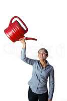 Happy woman holding a watering can over her head