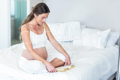 Pregnant woman reading novel