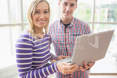 Portrait of college students using laptop