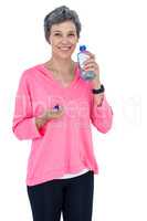 Portrait of happy mature woman drinking water