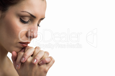 Close-up of woman praying with eyes closed