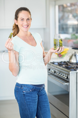 Portrait of happy woman with pickle jar