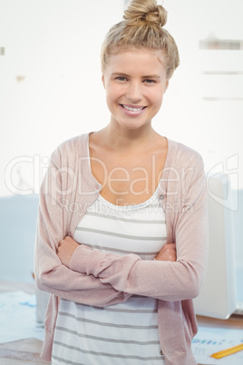 Portrait of smiling woman with arms crossed