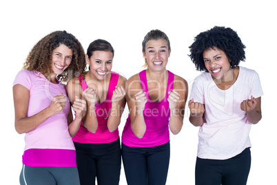 Portrait of smiling group of women with clasped hands