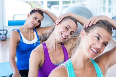 Portrait of woman doing head exercise with her friends