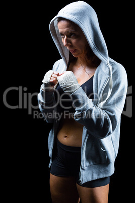 Female fighter in hood with fighting stance