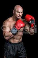 Bald boxer with red gloves