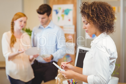 Businesswoman writing on document