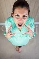 High angle portrait of screaming woman gesturing