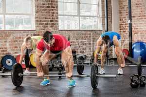 People lifting barbell