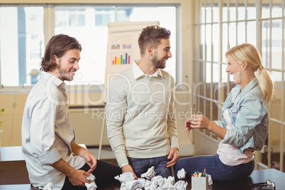 Happy business people with paper balls