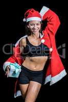 Portrait of happy athlete with hand behind head holding Christma
