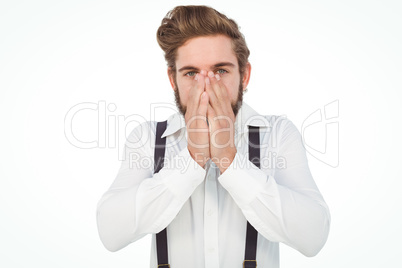 Portrait of hipster with hands covering mouth