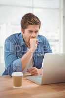 Businessman yawning while sitting at desk