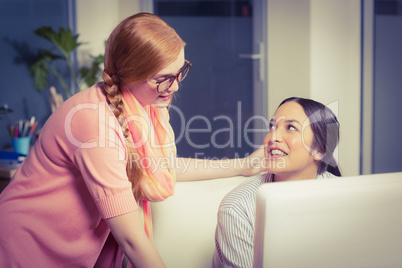 Female employee discussing with colleague in office