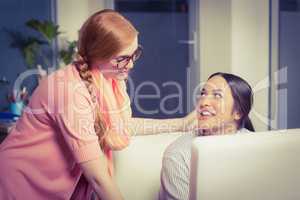 Female employee discussing with colleague in office