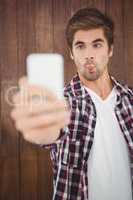 Man making face while taking selfie