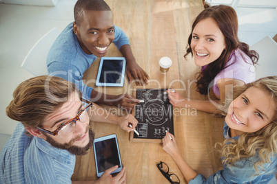 Overhead portrait of smiling business people writing business te