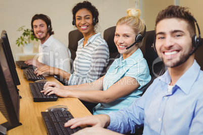 Portrait of smiling executives in call center