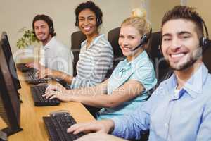 Portrait of smiling executives in call center