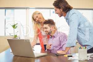 Business people at desk using laptop