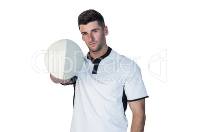 Portrait of rugby player holding the ball with one hand