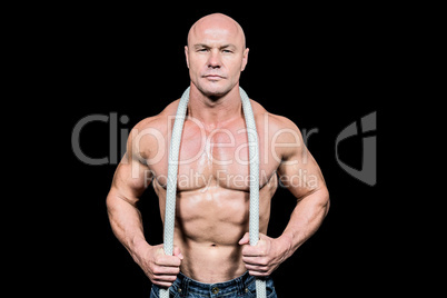 Portrait of muscular man holding rope