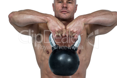 Close-up of kettlebell lifted by muscular man