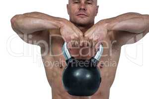 Close-up of kettlebell lifted by muscular man