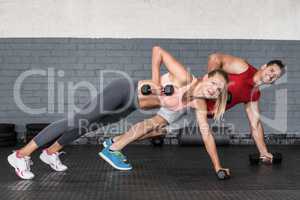 Fit couple doing dumbbell rows
