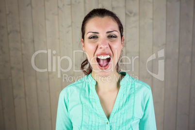Portrait of screaming woman suffering from headache