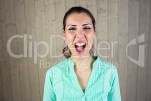 Portrait of screaming woman suffering from headache